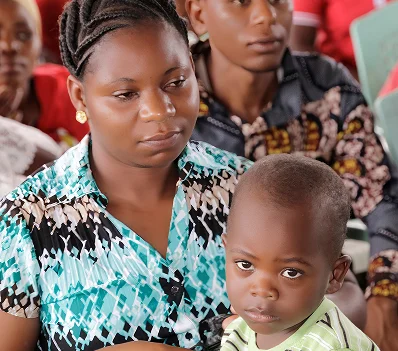A mother and young child at a service