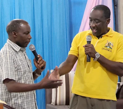 Two speakers sharing a microphone during a meeting