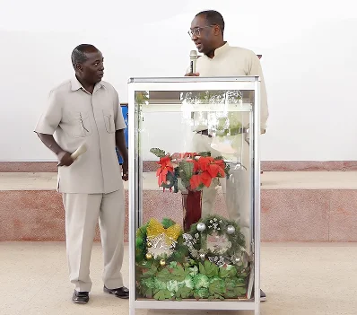 A minister speaking beside the pulpit