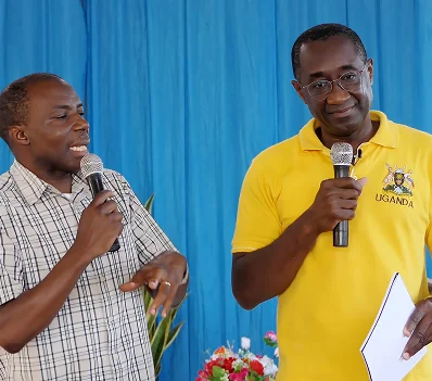 A speaker in a yellow shirt addressing the meeting