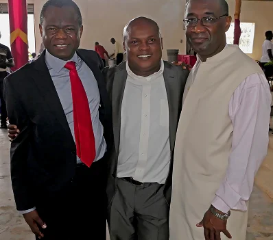 Three men standing together and smiling